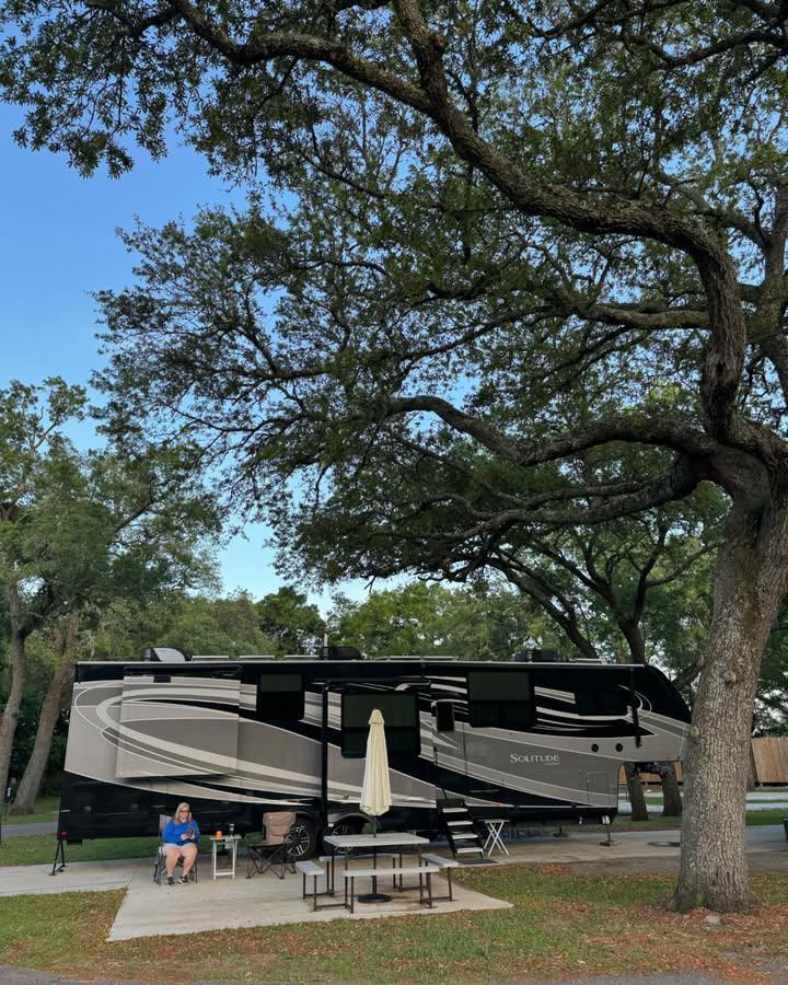 Our RV parked under the shade of a large Oak tree